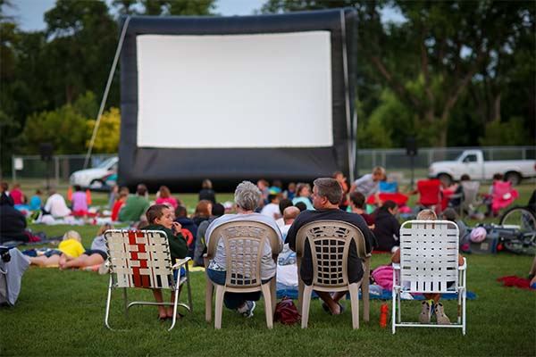 people watching a movie at a park
