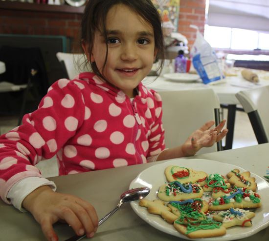 girl looking at cookies she has decorated